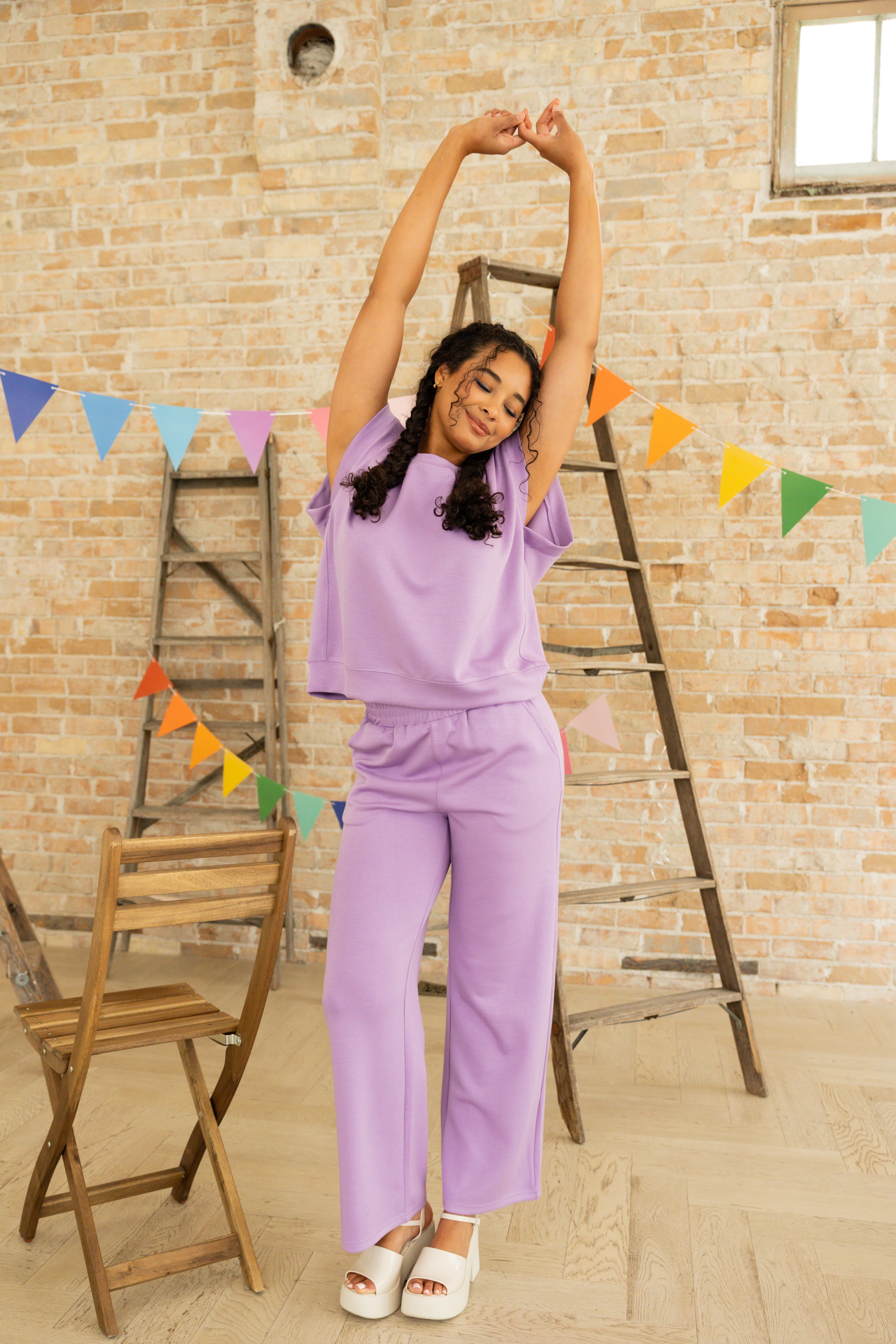 Model is wearing lavender short sleeve and pant lounge set.