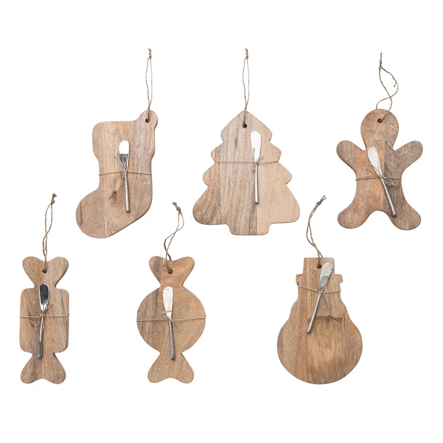 Set of wooden Christmas ornaments shaped like a fish, tree, stocking, and gingerbread man on a white background.