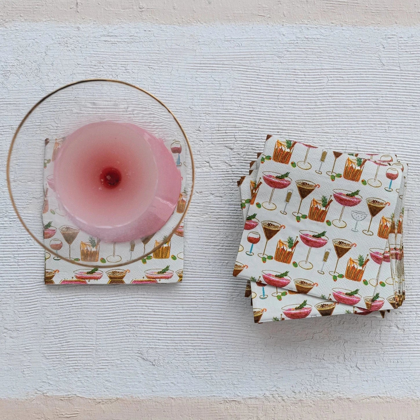 Set of coasters with a pink candle on a textured surface
